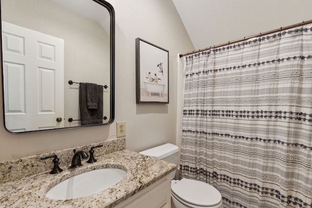 bathroom featuring walk in shower, lofted ceiling, vanity, and toilet