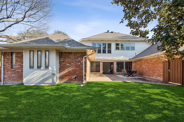 back of house featuring a patio and a yard