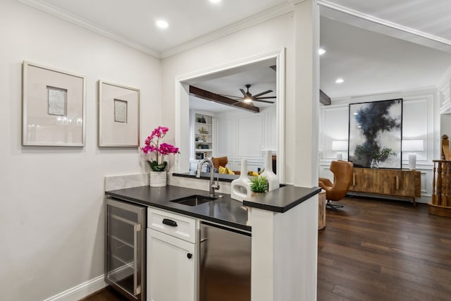 kitchen featuring dark hardwood / wood-style floors, stainless steel fridge, wine cooler, white cabinets, and sink