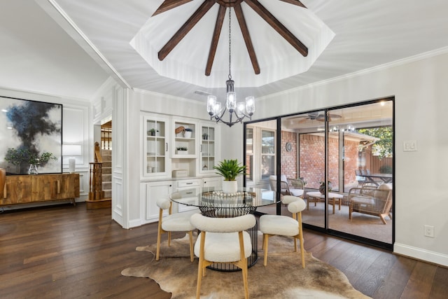 dining room with a chandelier, a tray ceiling, crown molding, and dark hardwood / wood-style floors