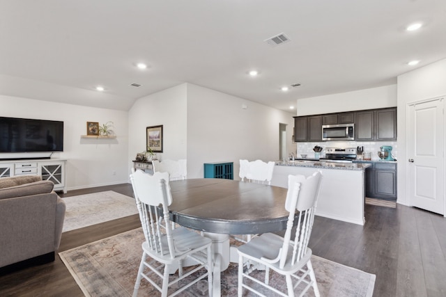 dining area with dark hardwood / wood-style flooring and lofted ceiling