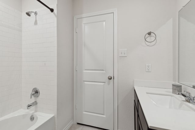 bathroom with vanity and tiled shower / bath combo