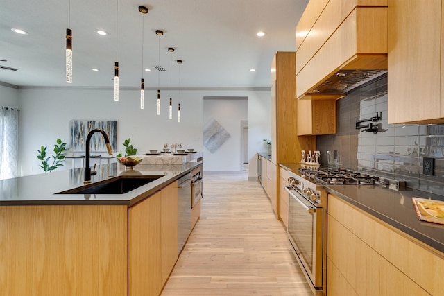 kitchen featuring premium range hood, hanging light fixtures, an island with sink, appliances with stainless steel finishes, and sink