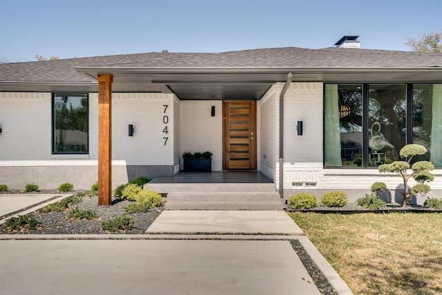 property entrance with a yard