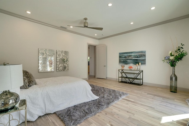 bedroom featuring ceiling fan, light hardwood / wood-style flooring, and ornamental molding