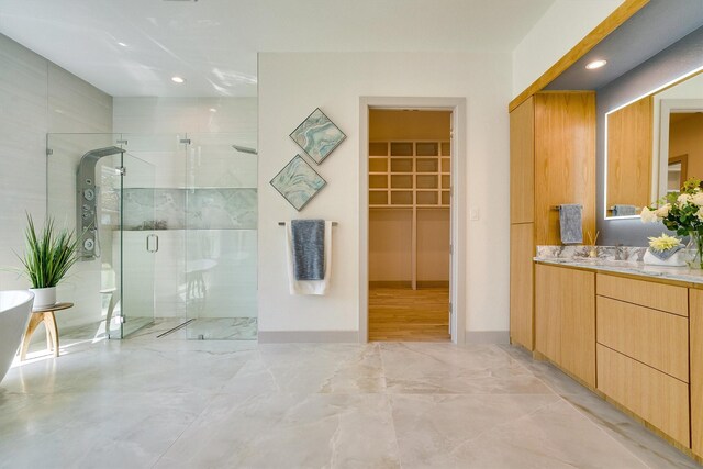 bathroom with an enclosed shower and vanity