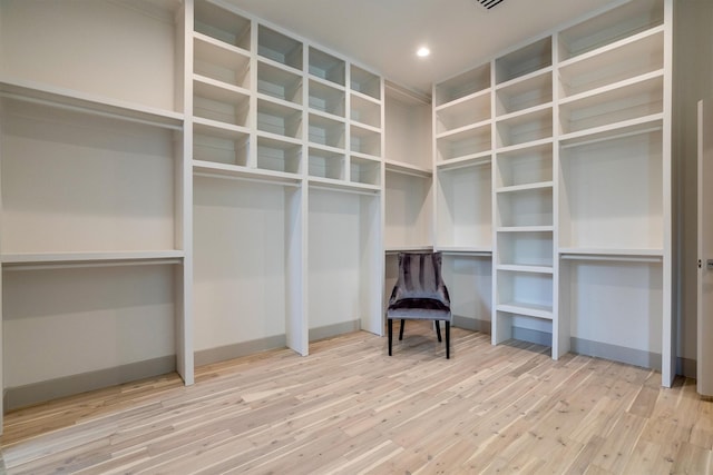 walk in closet featuring light hardwood / wood-style flooring