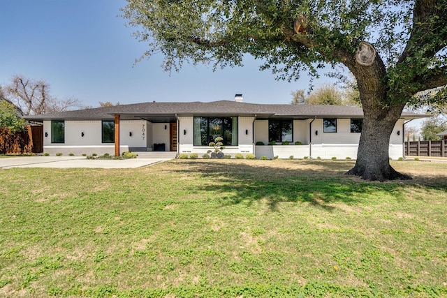 ranch-style home with a front lawn