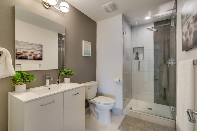 bathroom featuring walk in shower, vanity, tile patterned floors, and toilet