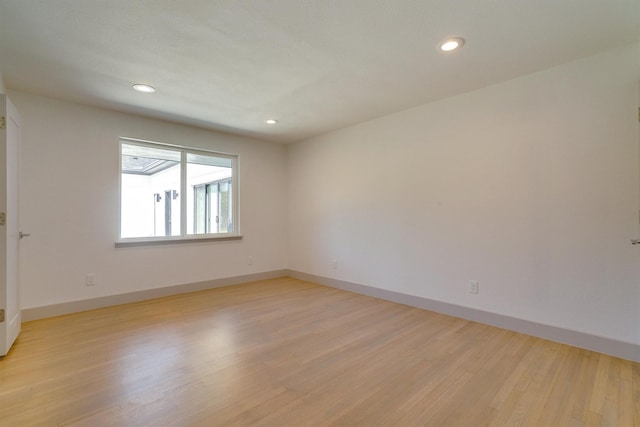 spare room with light hardwood / wood-style flooring