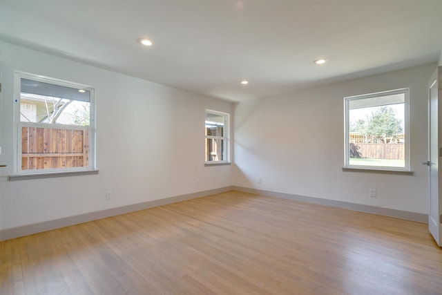 unfurnished room with light hardwood / wood-style floors and a healthy amount of sunlight