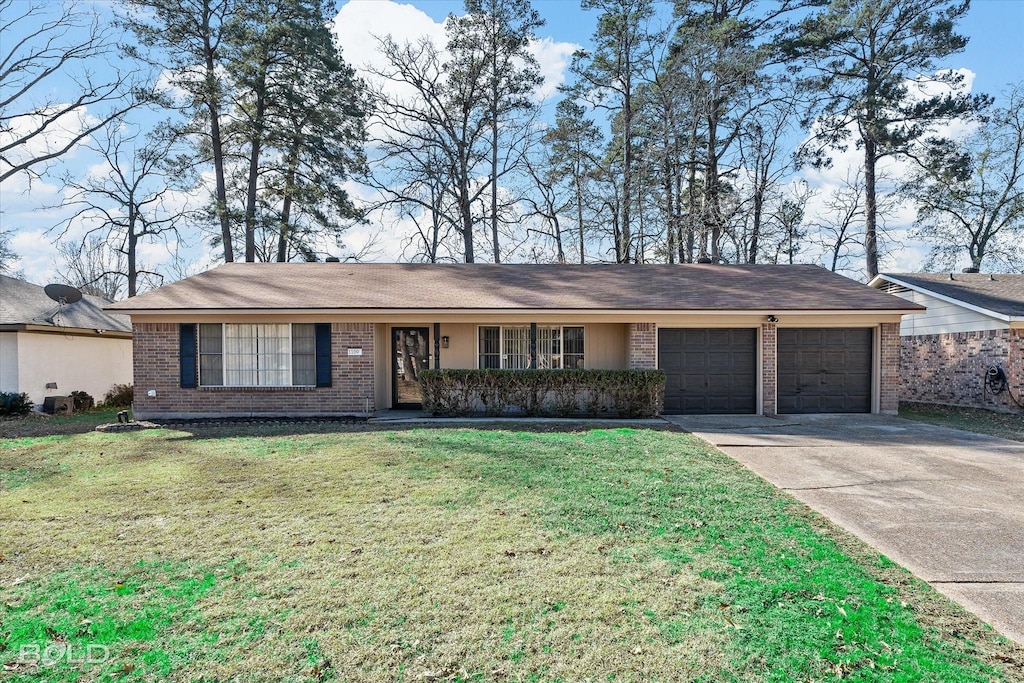 single story home with a front yard and a garage