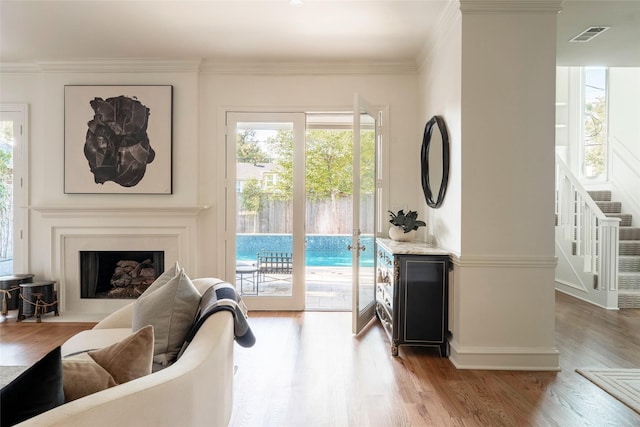 living room with hardwood / wood-style floors and crown molding