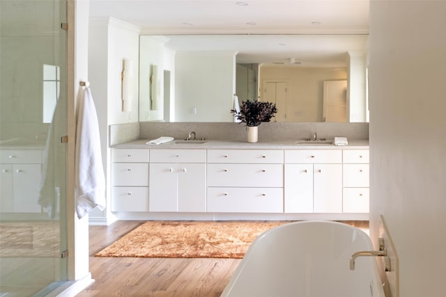 bathroom featuring ornamental molding, separate shower and tub, vanity, and wood-type flooring