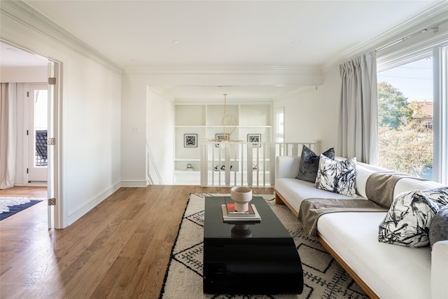 living room featuring a notable chandelier, hardwood / wood-style floors, and ornamental molding