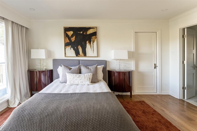 bedroom featuring dark hardwood / wood-style flooring and crown molding