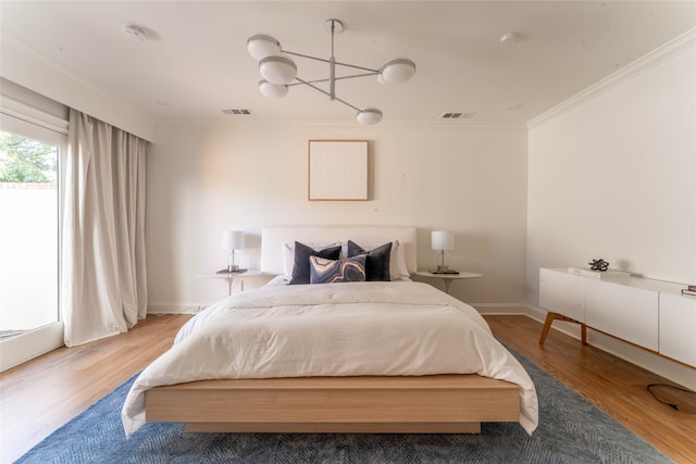 bedroom with hardwood / wood-style flooring and ornamental molding