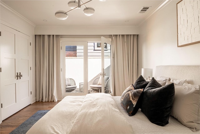 bedroom with crown molding and hardwood / wood-style flooring