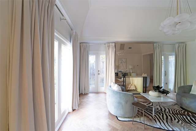 living room featuring lofted ceiling, french doors, ornamental molding, and light parquet floors