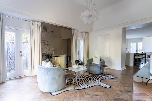 living area featuring french doors, light parquet flooring, and ornamental molding