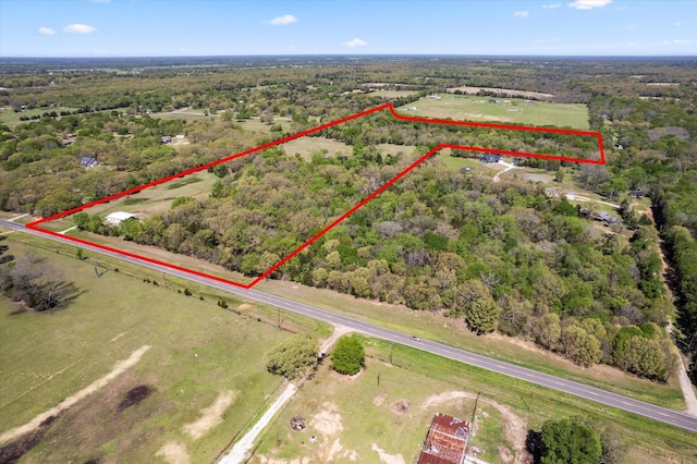 birds eye view of property with a rural view