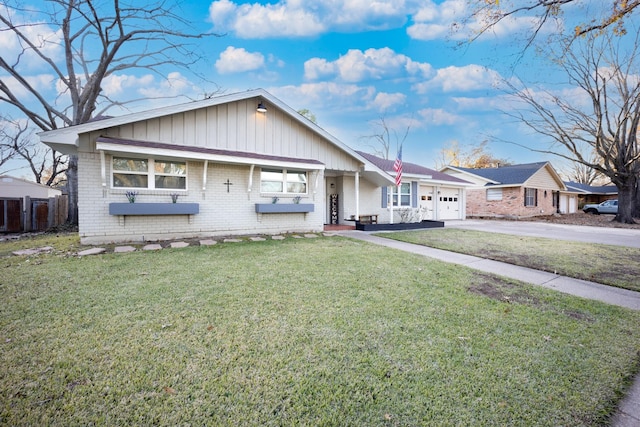 view of front of home featuring a garage and a front lawn