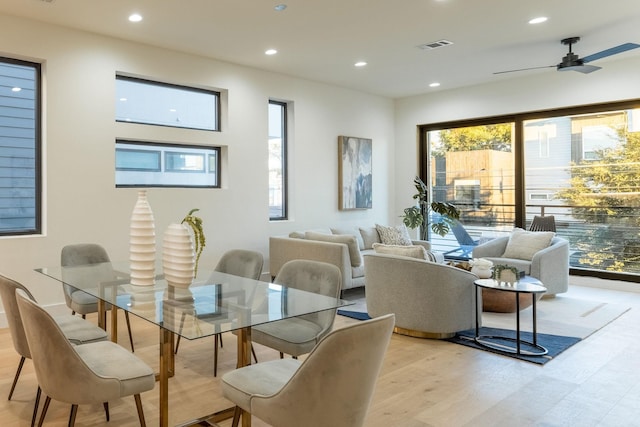 dining room with ceiling fan and light hardwood / wood-style floors