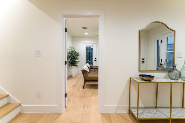 hallway with light hardwood / wood-style flooring