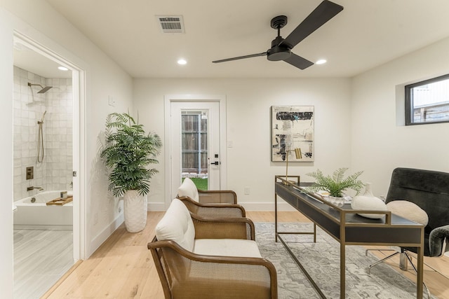 office space featuring light wood-type flooring and ceiling fan