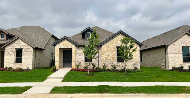 french country home featuring a front lawn