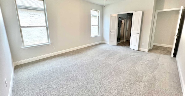 unfurnished bedroom with light carpet