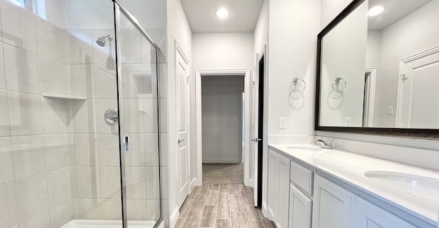 bathroom featuring an enclosed shower and vanity