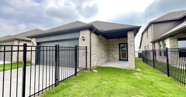 view of side of home with a lawn, central AC, a patio area, and a garage