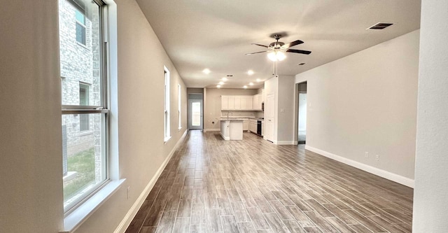 unfurnished living room with sink and ceiling fan