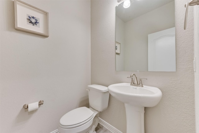 bathroom featuring sink and toilet