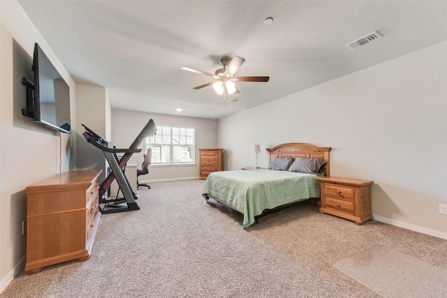 bedroom featuring light colored carpet and ceiling fan