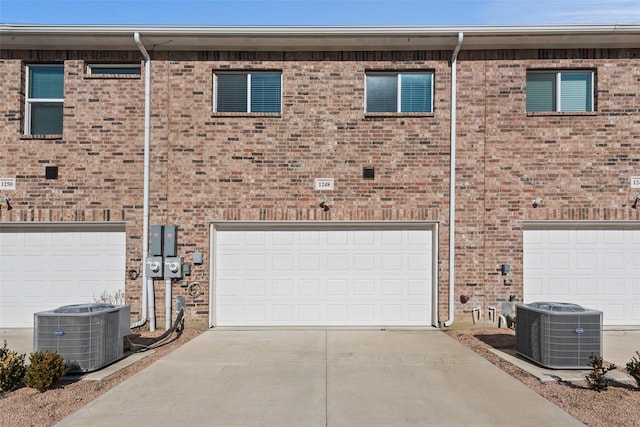 view of front facade with a garage and central AC unit