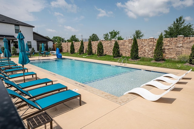 view of swimming pool featuring a patio