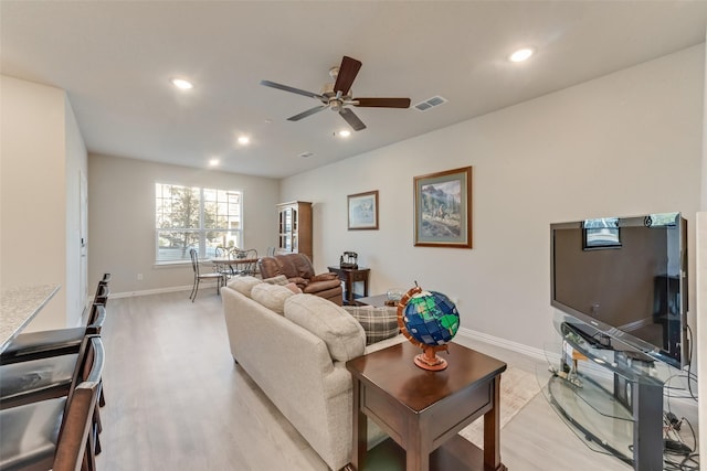 living room with ceiling fan and light wood-type flooring