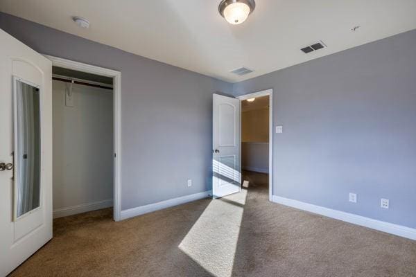 unfurnished bedroom featuring a closet and carpet flooring