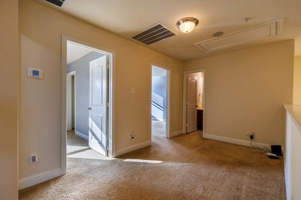 unfurnished room with light colored carpet