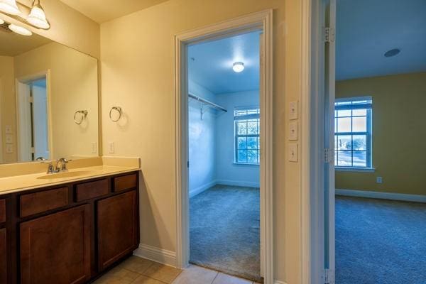 bathroom with tile patterned flooring and vanity