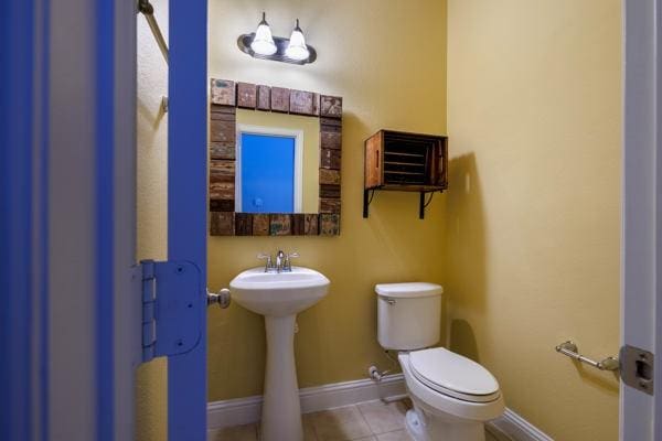 bathroom featuring toilet and tile patterned floors