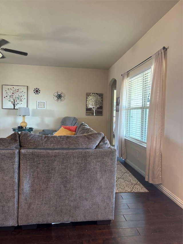 living room with ceiling fan and dark hardwood / wood-style floors