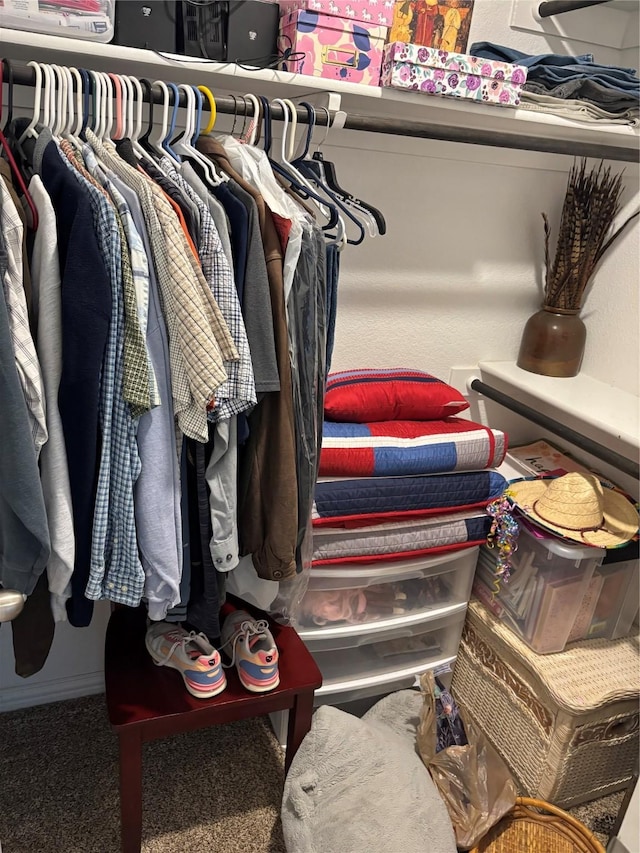 walk in closet with carpet flooring