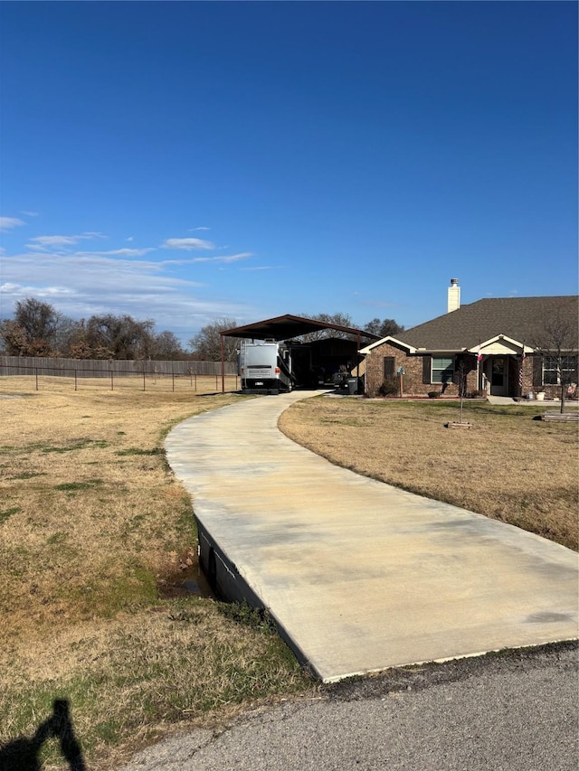 view of yard featuring a rural view and a carport