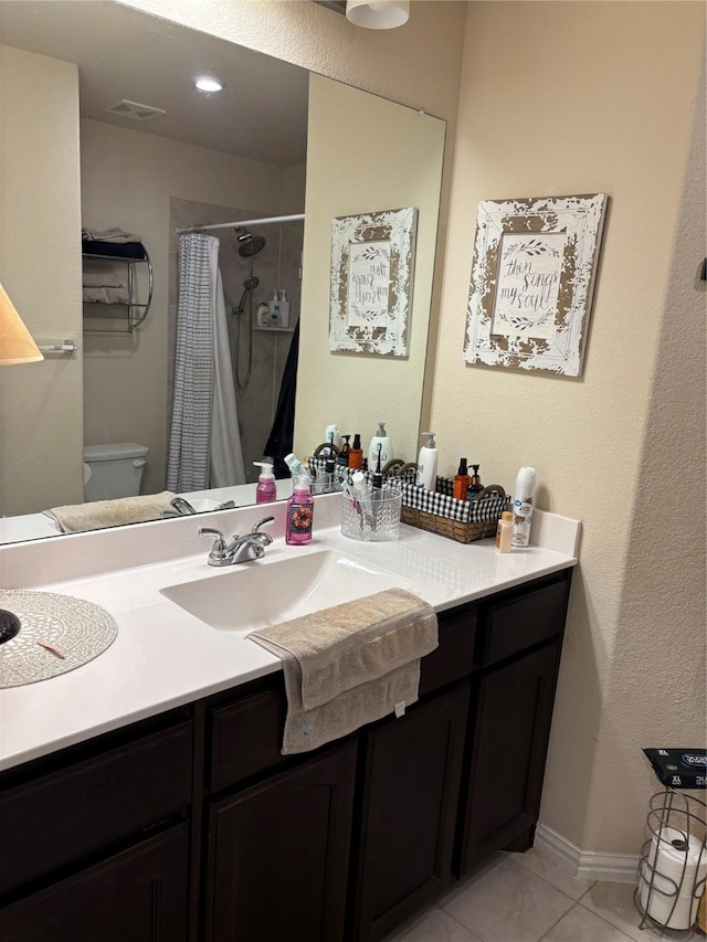 bathroom with toilet, vanity, tile patterned floors, and curtained shower