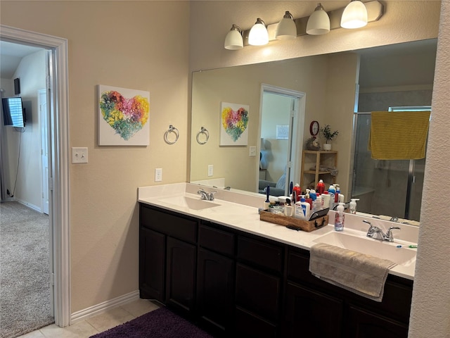 bathroom with tile patterned flooring, a shower with door, and vanity