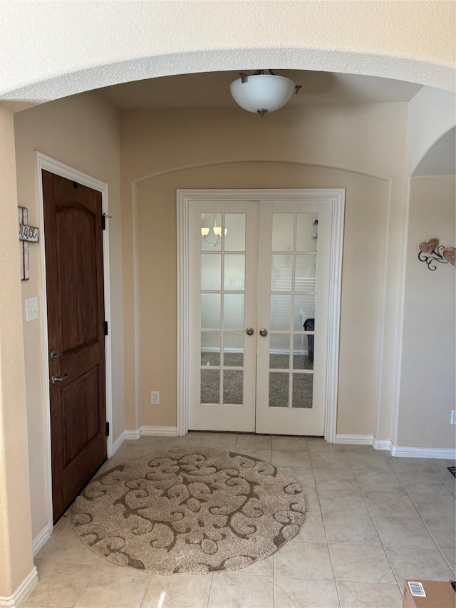 tiled foyer featuring french doors