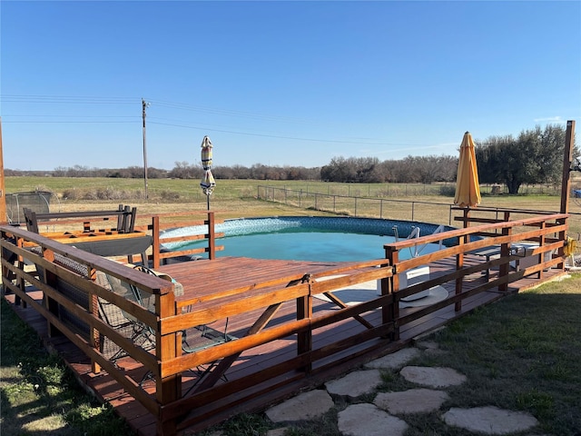 view of pool featuring a rural view and a deck